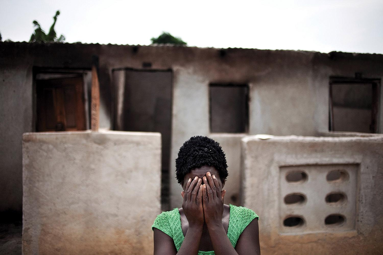 A woman hides her face after recounting how pro-Ouattara forces killed two of her children and her brother during the post-election violence in Duékoué, western Côte d’Ivoire.