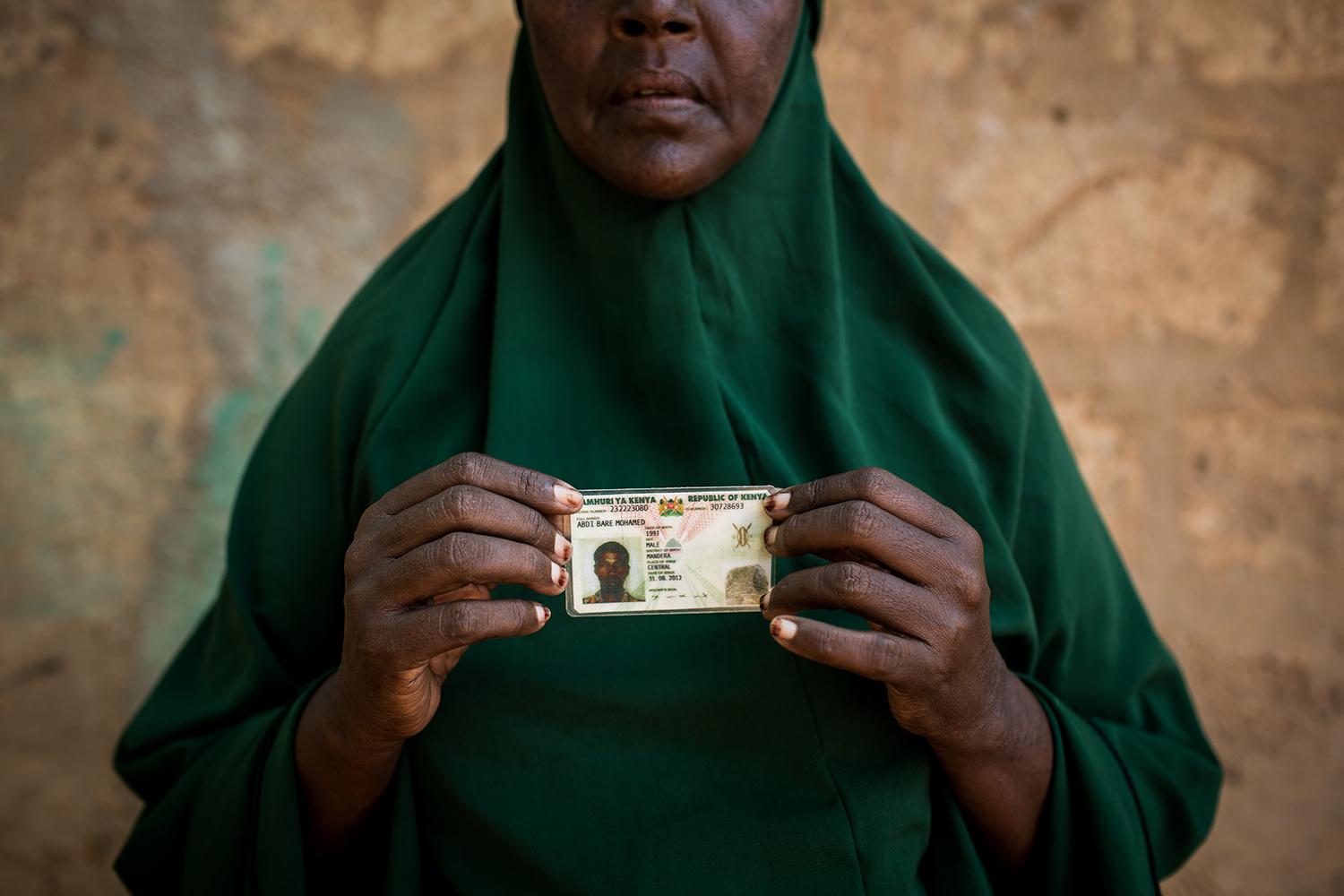 Zeinab Bulley Hussein holding the national identity card of her son, Abdi Bare Mohamed. Community members stumbled on Abdi Bare’s dead body 18 kilometers from Mandera, in northeastern Kenya, three weeks after police officers arrested him outside the famil