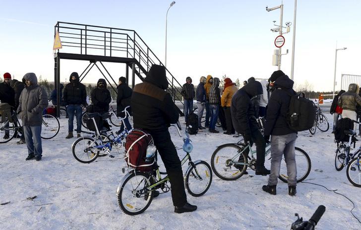 Refugees and migrants gather near a checkpoint on the Russian-Norwegian border in Murmansk region, Russia on October 30, 2015. 