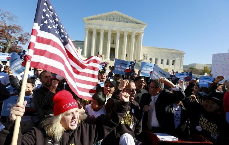 Immigrants and community leaders rally in front of the U.S. Supreme Court to mark the one-year anniversary of President Barack Obama's executive orders on immigration in Washington, November 20, 2015. 