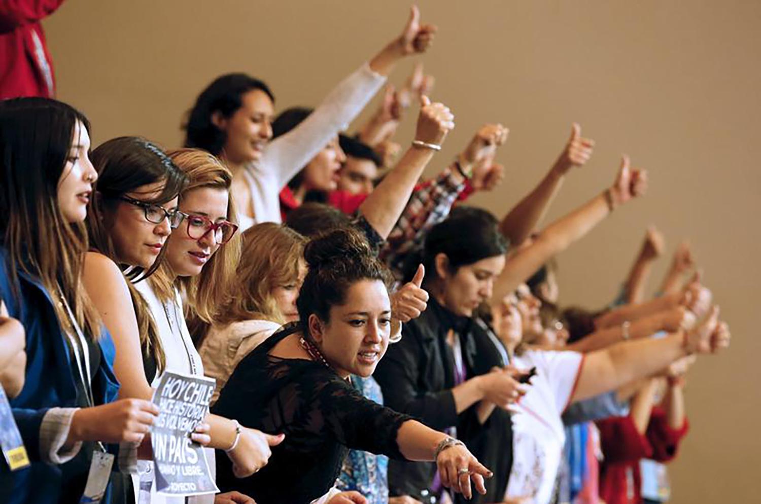 Demonstrators raises their thumbs in approval inside Congress in favor of a draft law by the government which seeks to ease the country's strict abortion ban, in Valparaiso, Chile, March 17, 2016. The law passed the Senate on July 19, 2017.