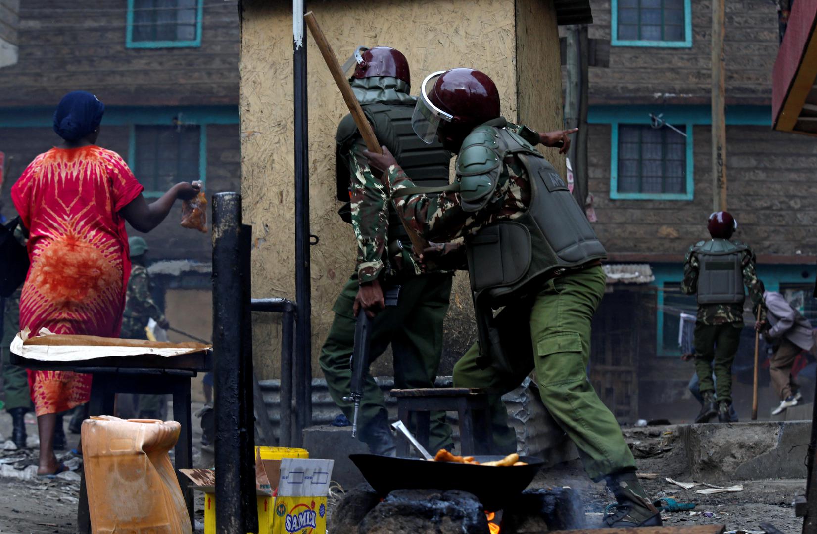  Residents flee as anti-riot policemen pursue opposition protestors in Mathare, Nairobi, on August 12. 