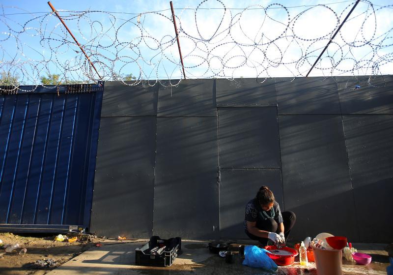 A refugee washes clothes on the Hungary-Serbia border, on the Serbian side of a transit zone set up by Hungarian authorities to filter refugees at Roszke, Hungary, September 2, 2016. 