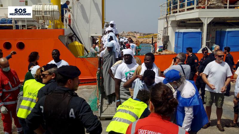 Migrants disembark from the SOS Mediterranee ship Aquarius at the Italian island of Lampedusa, April 18, 2016.
