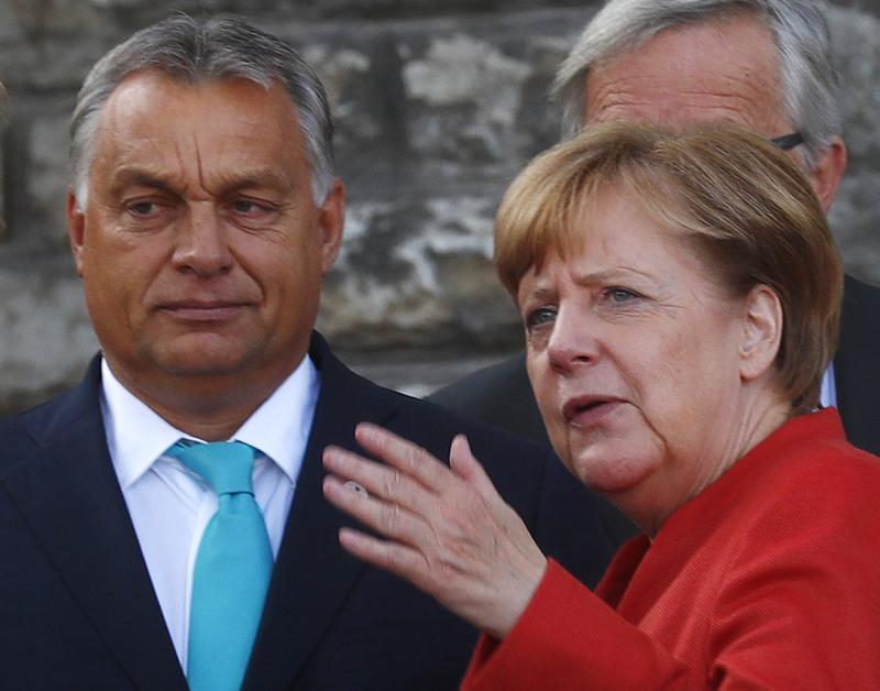 Germany's Chancellor Angela Merkel talks with Hungary's Prime Minister Viktor Orban before a photo at the European Union Tallinn Digital Summit in Tallinn, Estonia, September 29, 2017. 