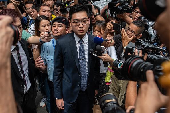Andy Chan (C), founder of the Hong Kong National Party, is surrounded by members of the media as he leaves the Foreign Correspondents' Club (FCC) in Hong Kong on August 14, 2018. 