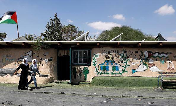 Deux filles palestiniennes marchent devant l’école de la communauté de Khan al-Ahmar, en Cisjordanie, le 6 septembre 2018.