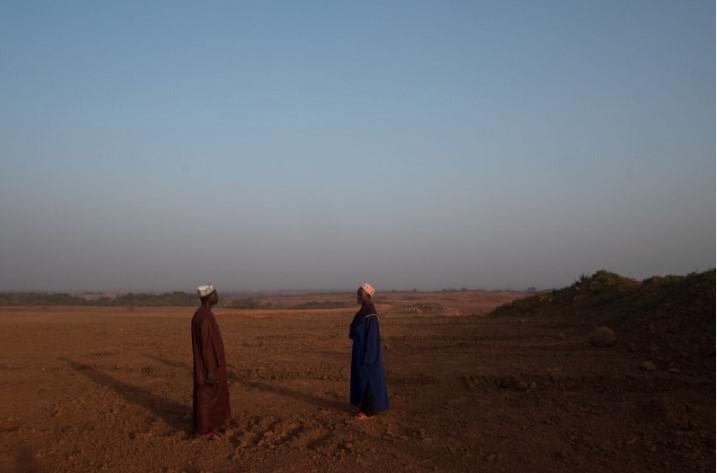 Farmers from Hamdallaye village, in the Boké region, look out over the village’s ancestral lands, which have been cleared by La Compagnie des Bauxites de Guinée for an expansion of mining operations. January 2018. 