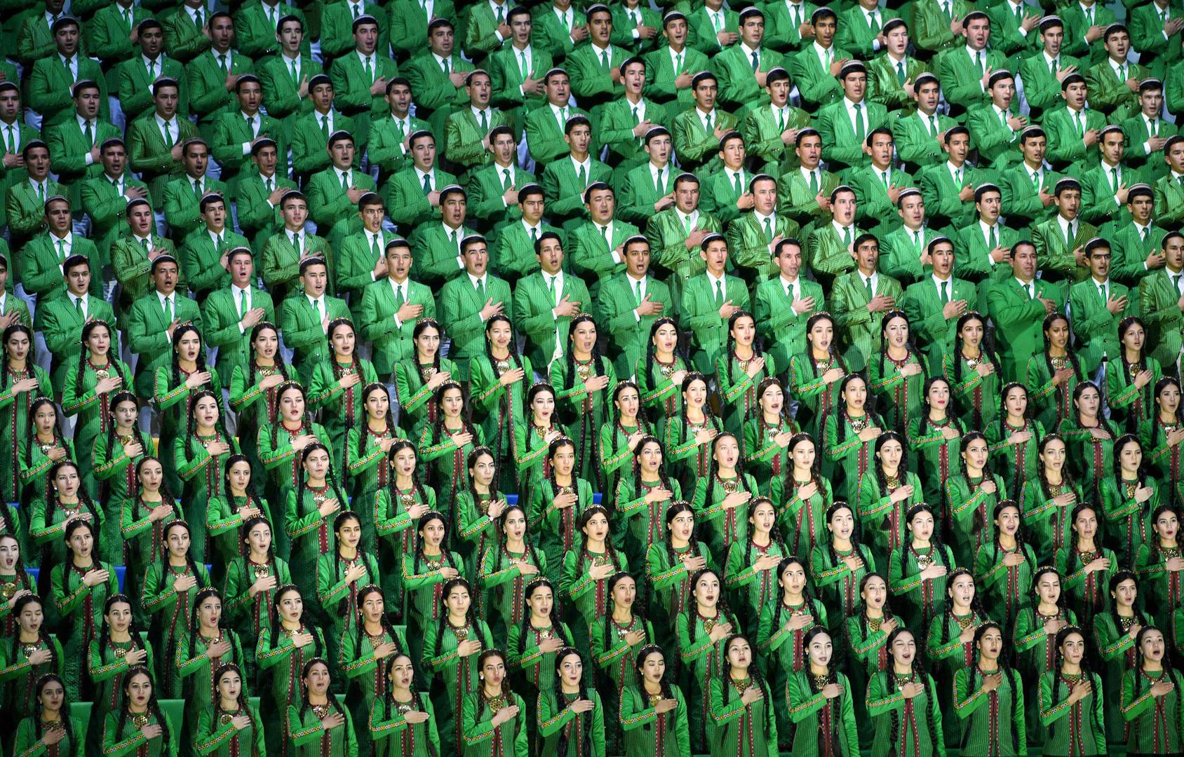 A Turkmen choir dressed in green, the national flag color, sings the national anthem at the opening ceremony of the world weightlifting championships.