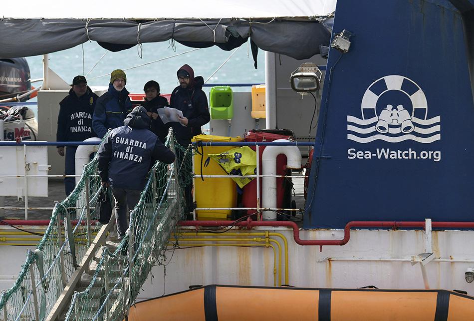 Italian Finance Police board the rescue ship Sea-Watch 3 after it disembarked 47 migrants at the Sicilian port of Catania, southern Italy, January 31, 2019.