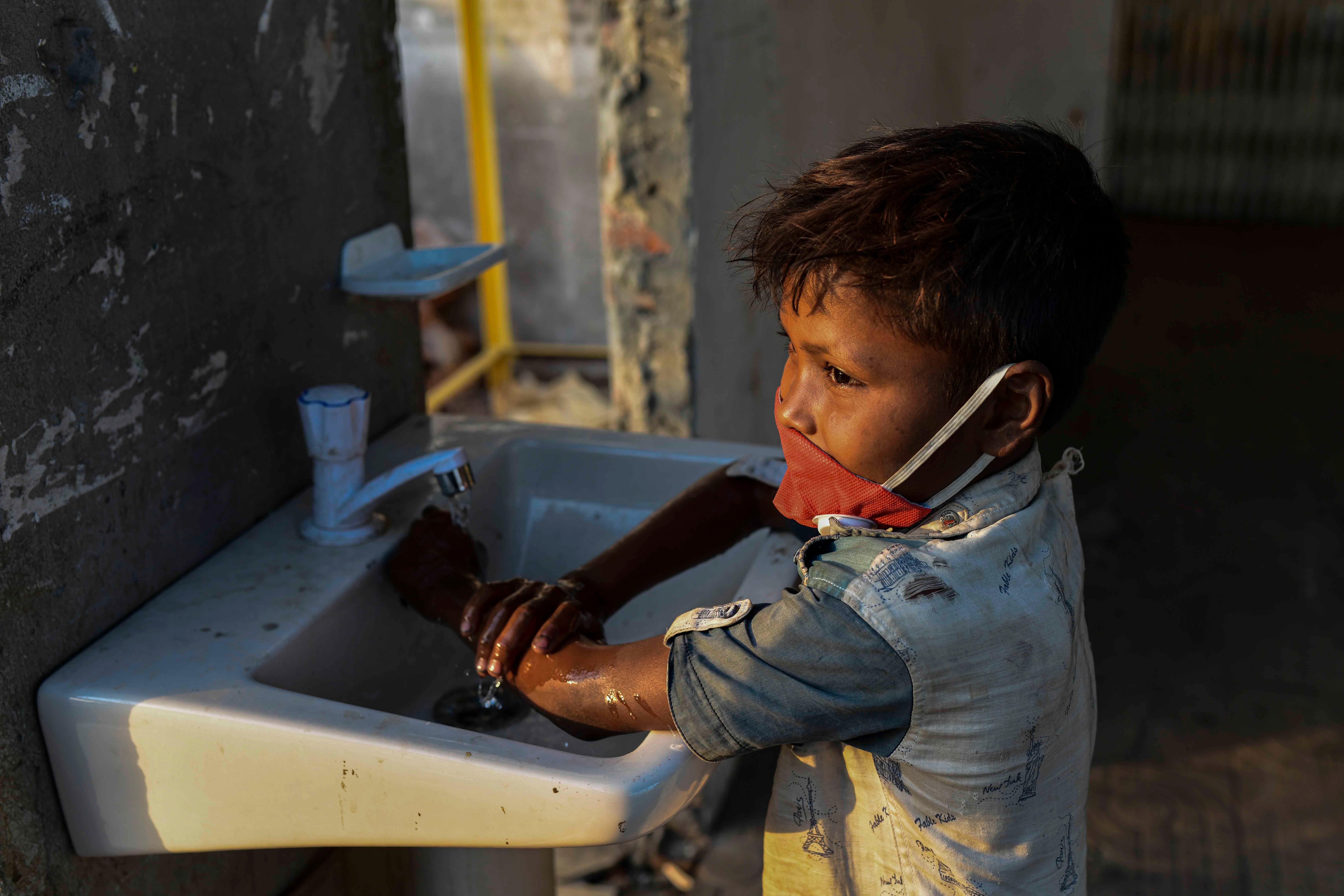 A child washing hands with anti-bacterial soap as a preventive measure against COVID-19, at Sadarghat Launch Terminal, in Dhaka, Bangladesh, on March 27, 2020.
