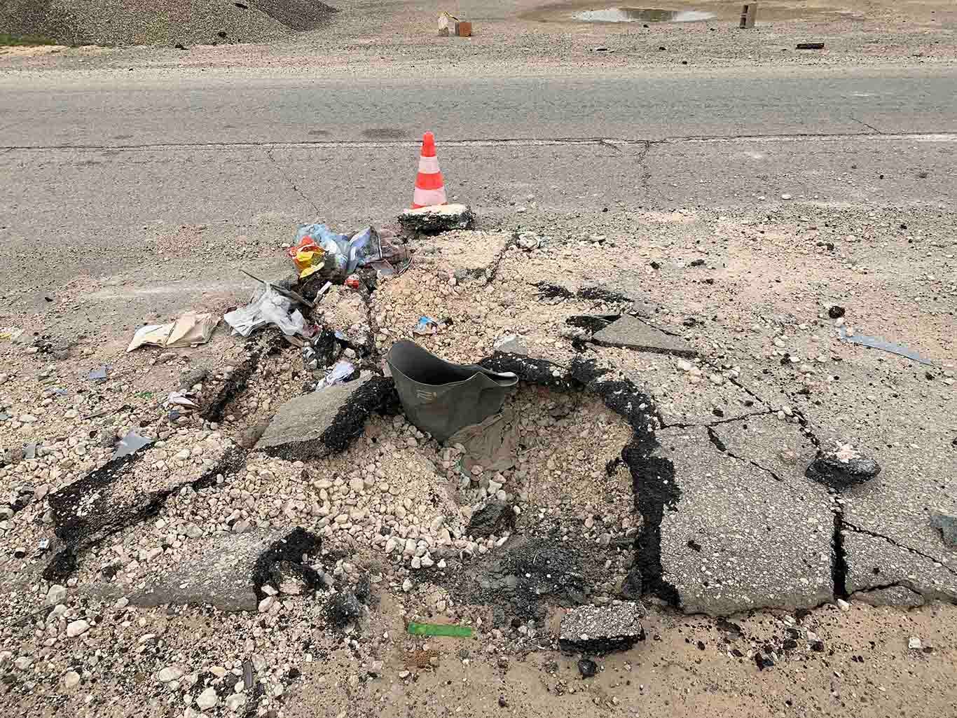 An expended cargo section of an RBK-250 PTAB-2.5M cluster bomb impacted into Alasfah Road near Tripoli International Airport following an attack on or around December 2, 2019, Tripoli outskirts, Libya,  December 18, 2019.