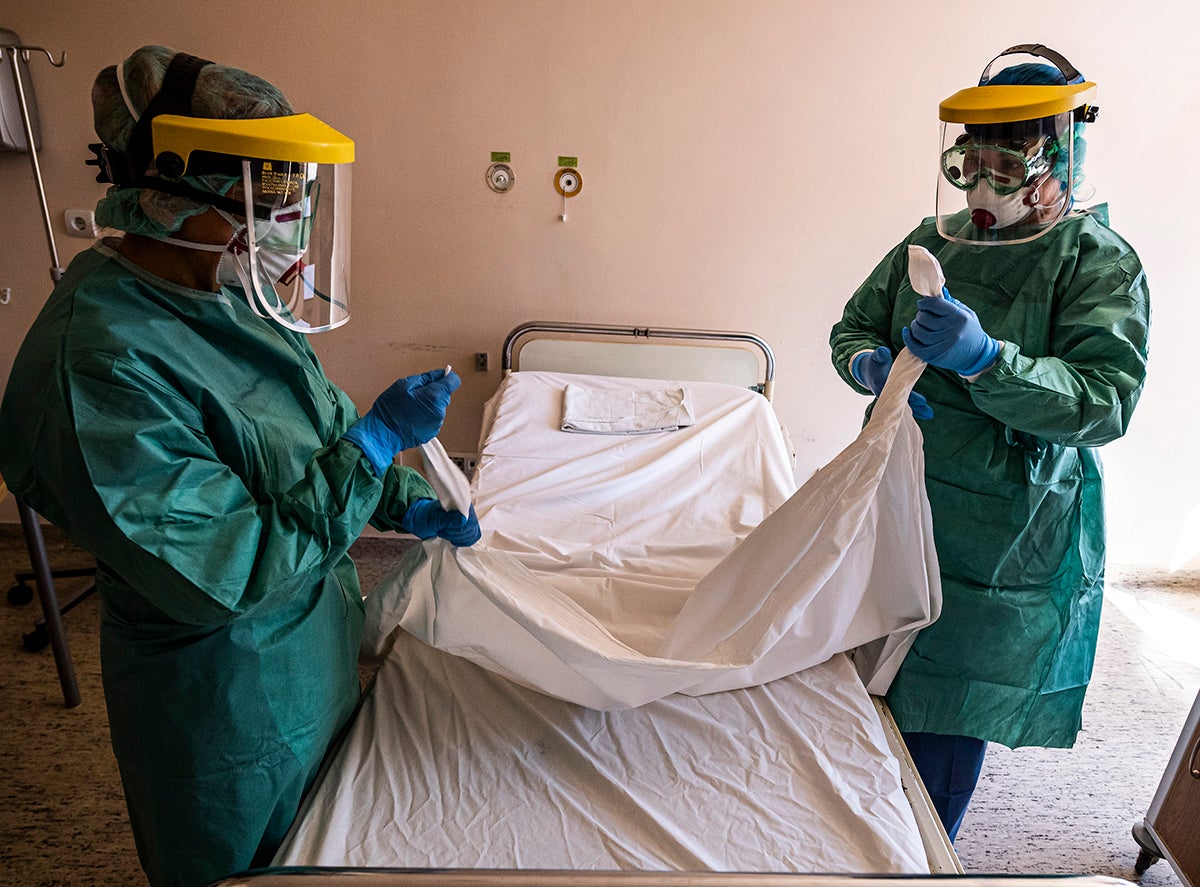 Nurses in protective gear prepare a ward designated for new patients infected with Covid-19 in a hospital in Budapest, Hungary, March 16, 2020.