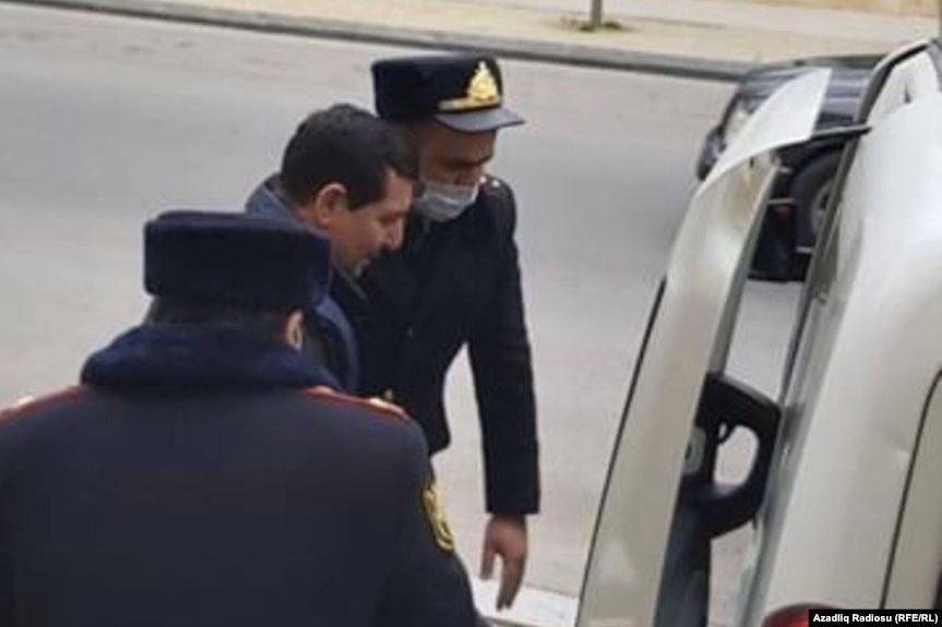 Policemen take opposition APFP member Faig Amirli from the Sabayel District Court of Baku into police custody on April 9, 2020.