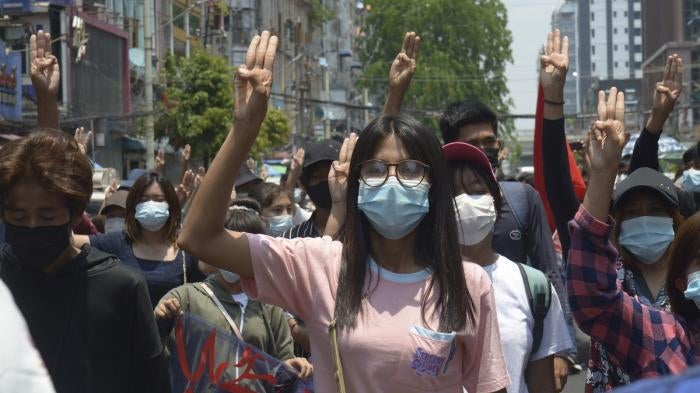 Anti-coup protesters flash the three-finger sign of defiance during a demonstration in Yangon, Myanmar on April 23, 2021.