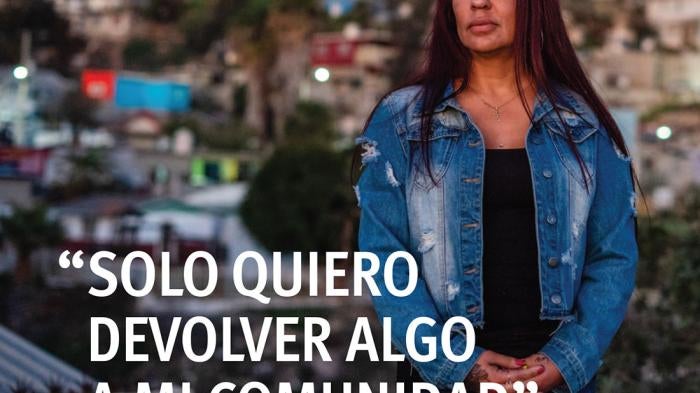 Report cover showing Gabby S. posing for a portrait in front of a cityscape