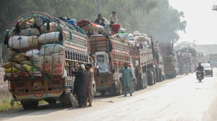 Trucks loaded with the belongings of Afghan refugees who are being forced to leave Pakistan outside the United Nations refugee agency repatriation centers in Azakhel town in Nowshera, Pakistan, October 30, 2023. 