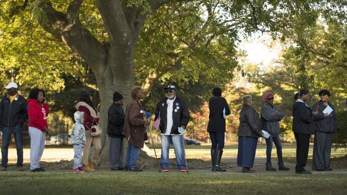 People stand in line to vote