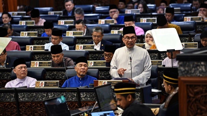 Malaysia’s Prime Minister and Finance Minister Anwar Ibrahim delivers the 2025 budget speech at parliament