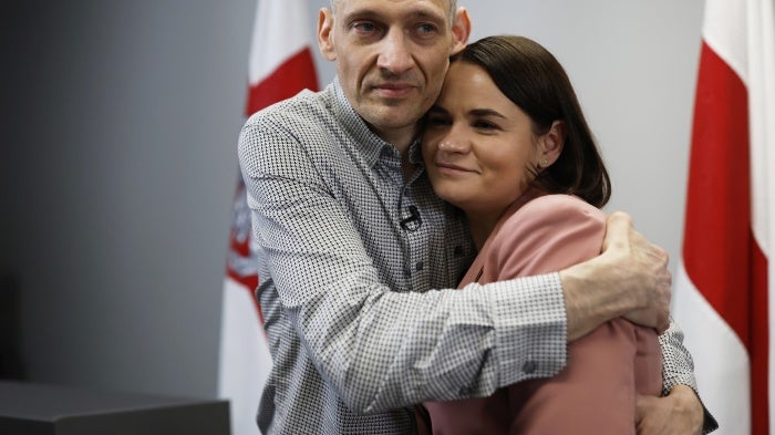 Belarusian opposition politician Syarhei Tsikhanouski (L), released from prison, embraces his wife, opposition leader Sviatlana Tsikhanouskaya, after a news conference in Vilnius, Lithuania, June 22, 2025. 
