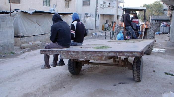 Palestinian laborers, including a 16-year-old, head out to work at a farm on an Israeli settlement in the West Bank.