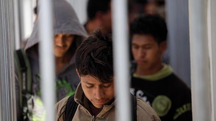 Men recently deoported from the United States wait in line to be registered with Mexican authorities at the border in Nogales, Mexico.