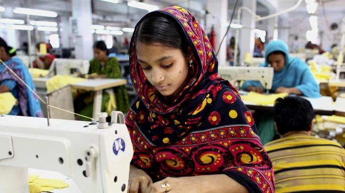 “A garment worker sews clothing in a building near the site of the Rana Plaza building collapse” © 2014 G.M.B. Akash/Panos.
