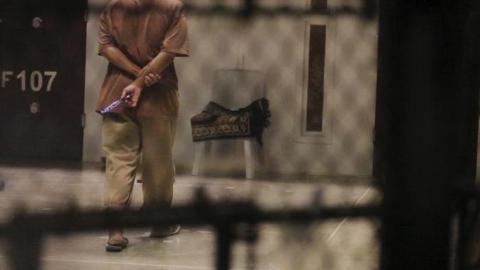 A detainee paces around a cell block while being held in Joint Task Force Guantanamo's Camp VI at the U.S. Naval Base in Guantanamo Bay, Cuba March 22, 2016.