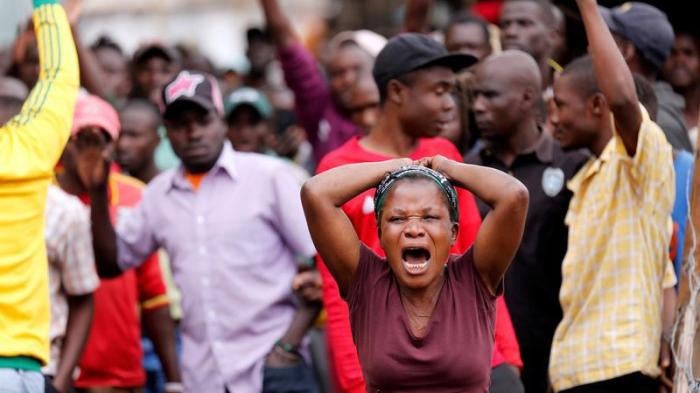 A woman reacts near the dead body of a protester in Mathare, in Nairobi, Kenya August 9, 2017. REUTERS/Thomas Mukoya