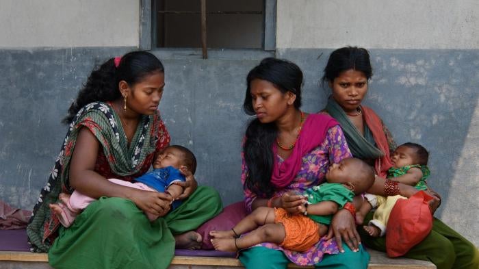 Women and girls wait with their children outside a doctor’s office in Chitwan, Nepal. 