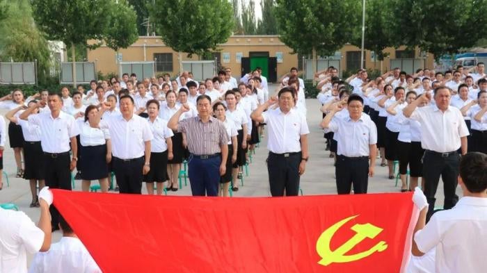 Village officials swear allegiance to the Chinese Communist Party in Kashgar, Xinjiang. 