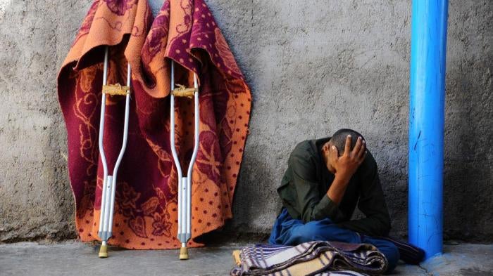 A man sits in the yard at a mental health facility in the city of Herat, April 2014. © 2014 Aref Karimi/AFP/Getty Images
