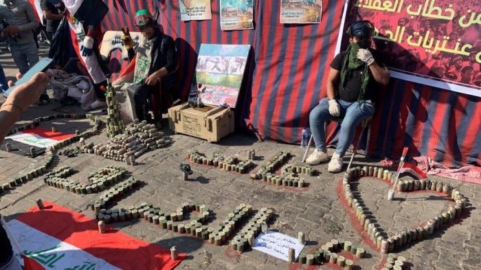 Protesters in Tahrir Square arrange the tear gas canisters that security forces fired at them in Tahrir Square in different patriotic constellations.