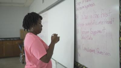 Woman at white board
