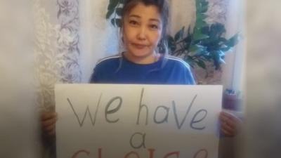 Photo of woman holding sign saying, "We have a choice."