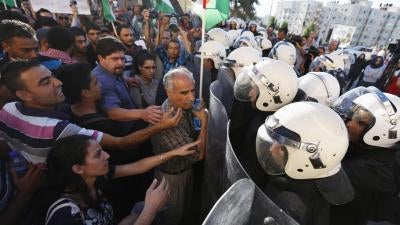 Palestinian riot police confront demonstrators protesting security coordination between the Palestinian Authority (PA) and Israel, in the West Bank city of Ramallah on June 23, 2014.