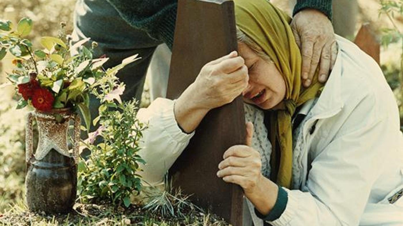 Photo 4A mother grieves over the grave of her 2nd son, and last child, who, along with his brother, were killed during the siege of Sarajevo.
