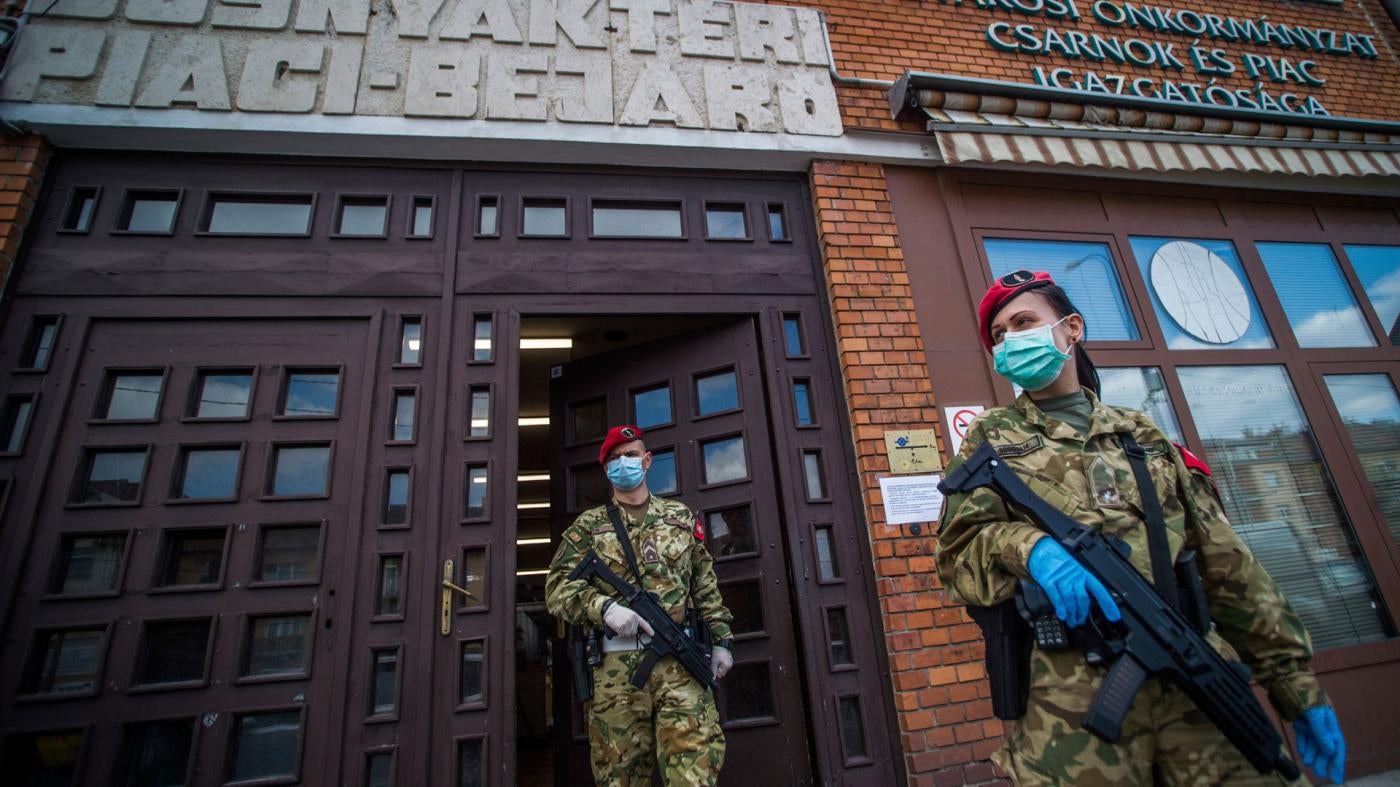 Military police officers patrol at a market in Budapest, Hungary, March 31, 2020.