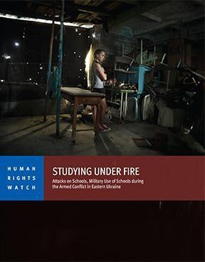 A former student, 13, stands in a damaged school in Vuhlehirsk.