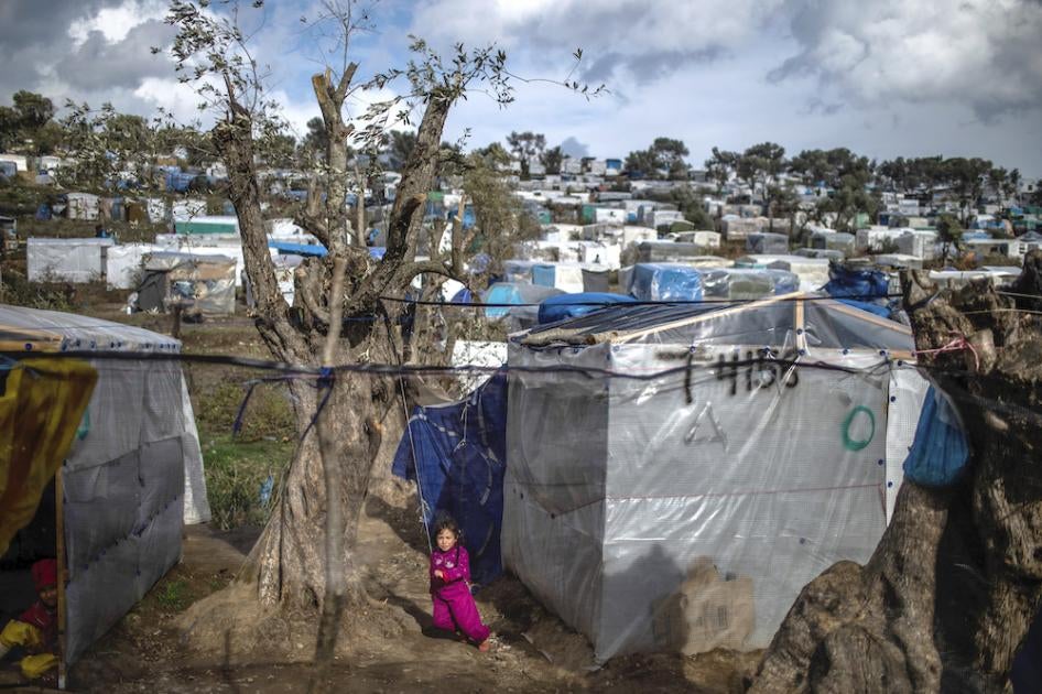A child plays in a temporary tent camp near the camp for migrants in Moria, Lesbos which is overcrowded and lacks adequate hygiene facilities and sanitation, putting migrants, including pregnant people, at particular risk amid Covid-19