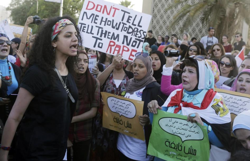 Women chant slogans as they gather to protest sexual harassment in front of the opera house in Cairo on June 14, 2014. 