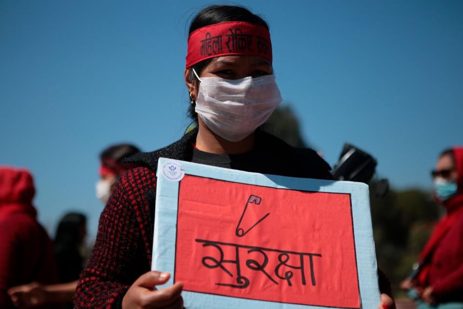 A woman holds a placard during a demonstration on International Women's Day to protest against inequality and sexual violence, March 8, 2020.