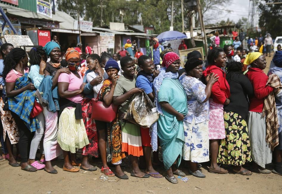 Woman stand outside in a closely packed line