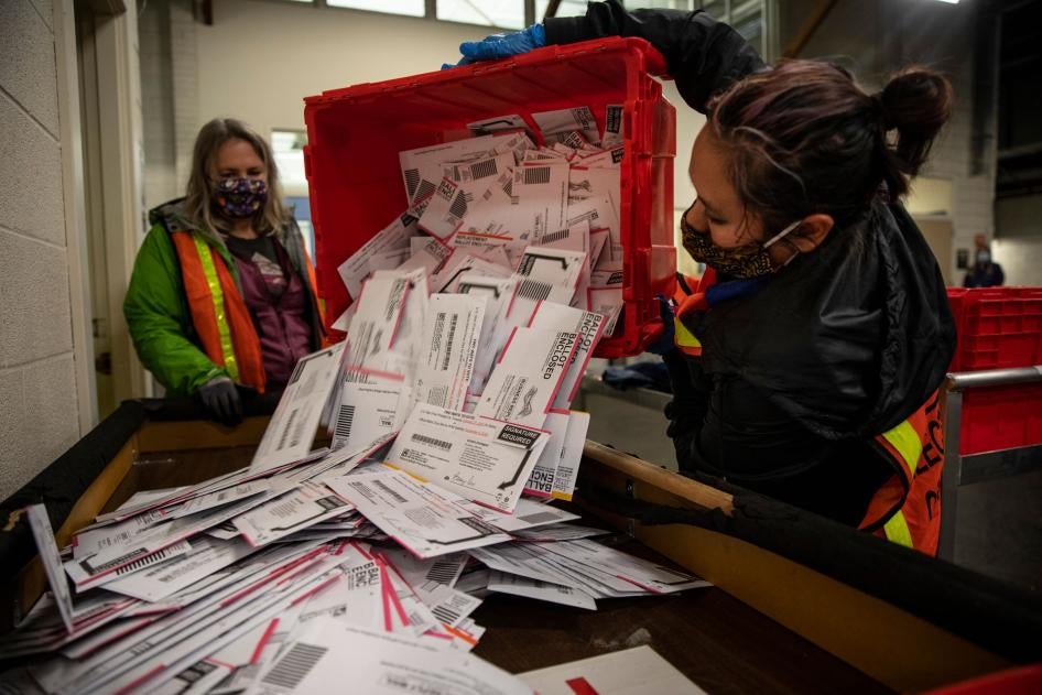 Election workers empty ballots at the Multnomah County Elections Division in Portland, Oregon, November 3, 2020. 