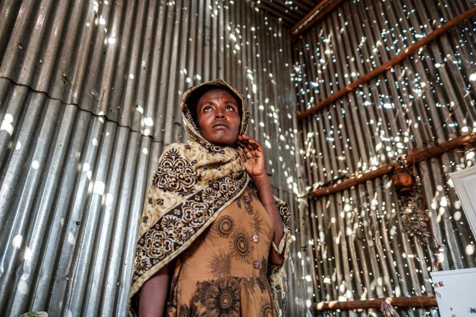 A woman stands in a metal sheet room that was damaged by shelling in Humera town, Tigray region, Ethiopia, on November 22, 2020. In that residential compound, two women and an elderly man were killed by shelling and gunfire, and two women were wounded.