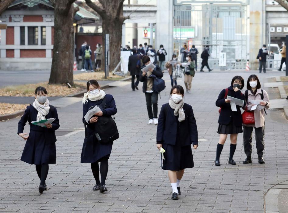 High school students wearing face masks walk in Tokyo, January 16, 2021. 