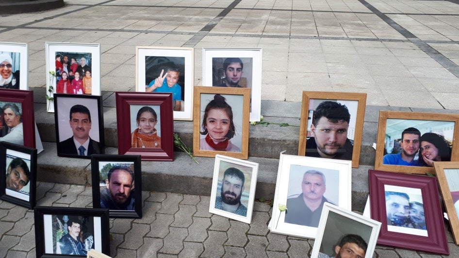 Photos of Syrians who have been detained or disappeared set up by Families for Freedom, as part of a protest in front of the court in Koblenz, July 2, 2020. 