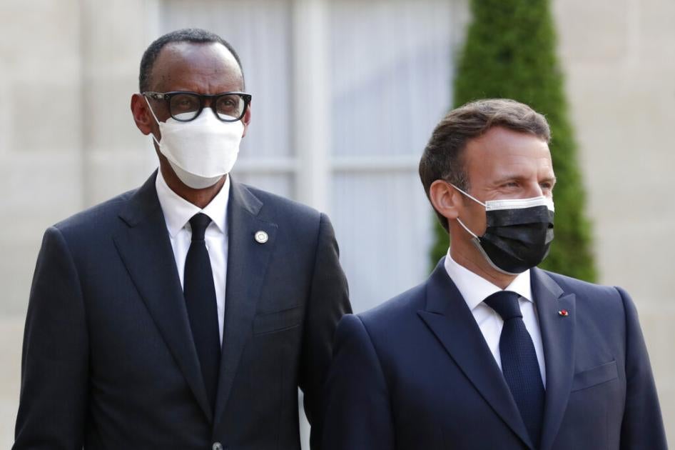French President Emmanuel Macron, right, welcomes Rwanda President Paul Kagame at a dinner for leaders of African states, at the Elysee Palace, Paris, May 17, 2021.