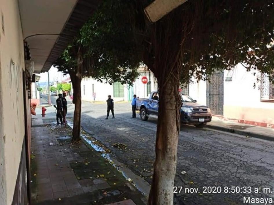Armed police officers on an empty residential street