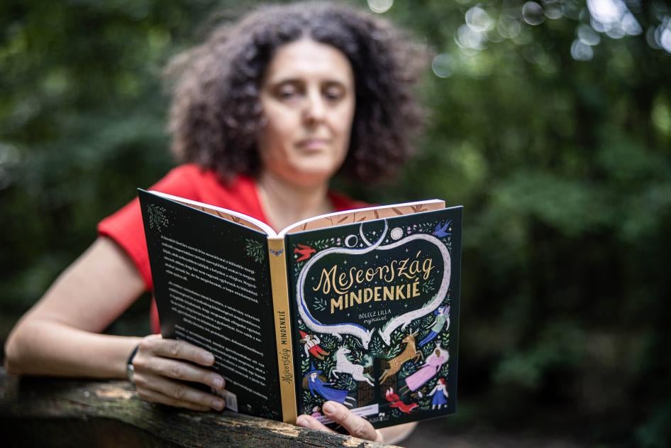 A woman reads from a book